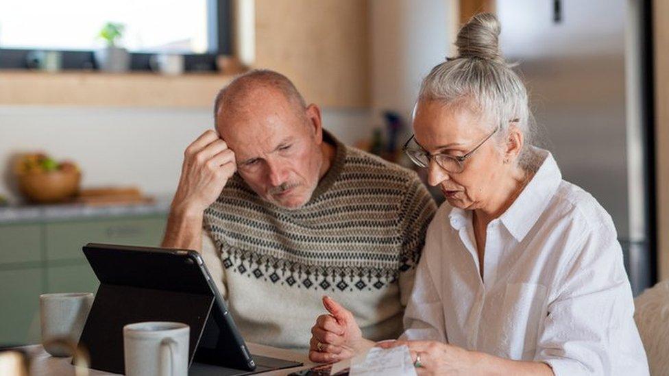 (stock image) man and a woman at a kitchen table