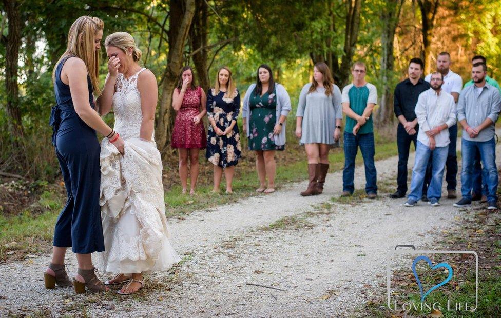 Jessica standing with family and friends