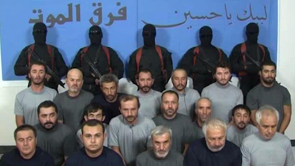 Kidnapped Turkish construction workers appear in a video in front of masked gunmen and banner saying "Death Squad" and "We are at your service, Hussein" (11 September 2015)