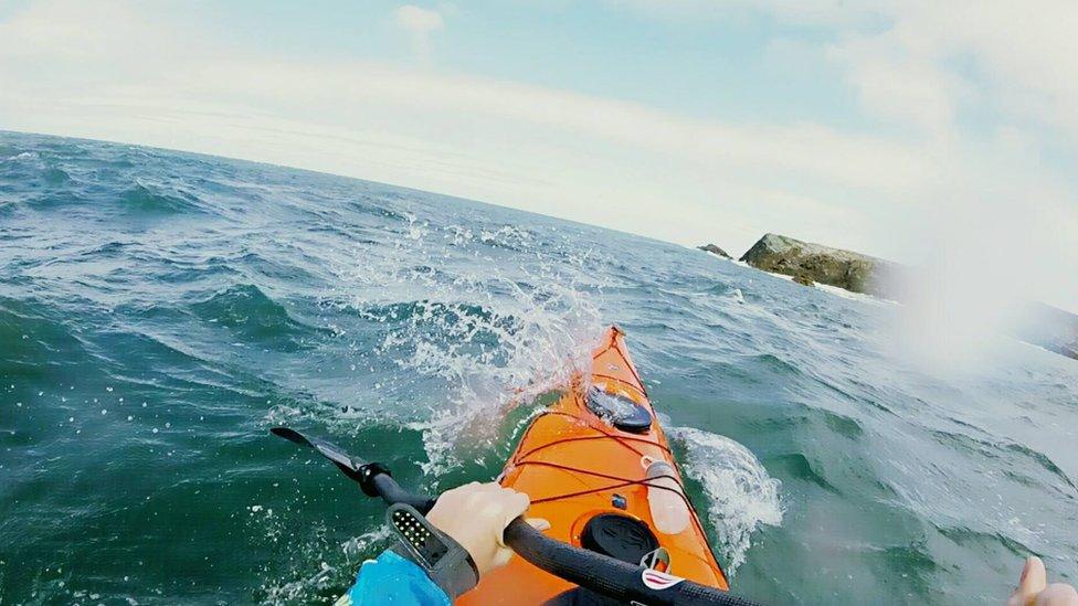 A first person shot of him kayaking