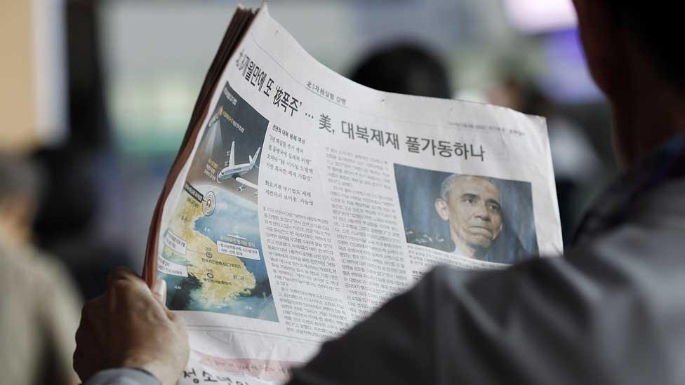 A South Korean reads a newspaper reporting North Korea's nuclear test in Seoul