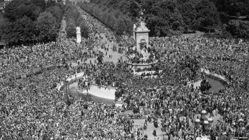 Jubilant crowds gathered outside Buckingham Palace on VJ Day in 1945