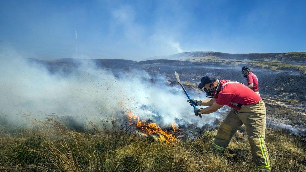 Firefighters tackling the fire at Winter Hill