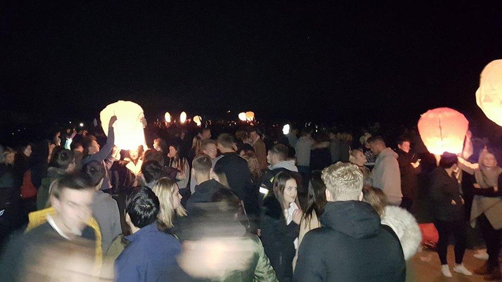 People releasing lanterns