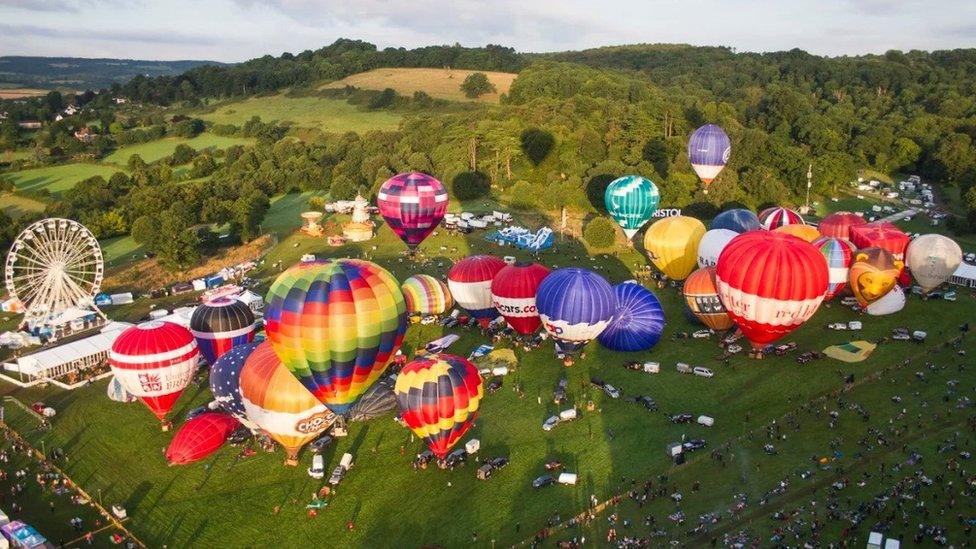 Hot air balloons taking off from fiesta