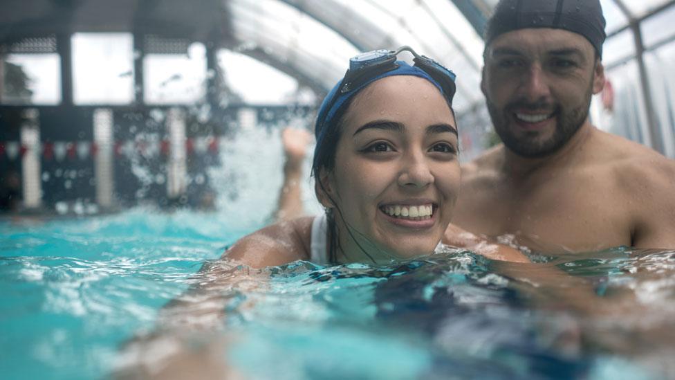 A woman having swimming lessons