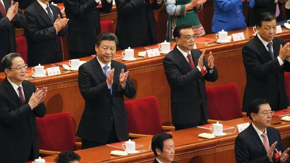 China's President Xi Jinping (2nd row, 2nd L), Premier Li Keqiang (2nd row, 2nd R), Politburo Standing Committee member Liu Yunshan (2nd row, R) and Chairman of the National Committee of the Chinese People's Political Consultative Conference (CPPCC) Yu Zhengsheng (2nd row, L) clap during the closing ceremony of National People's Congress (NPC) at the Great Hall of the People in Beijing, China, 16 March 2016.