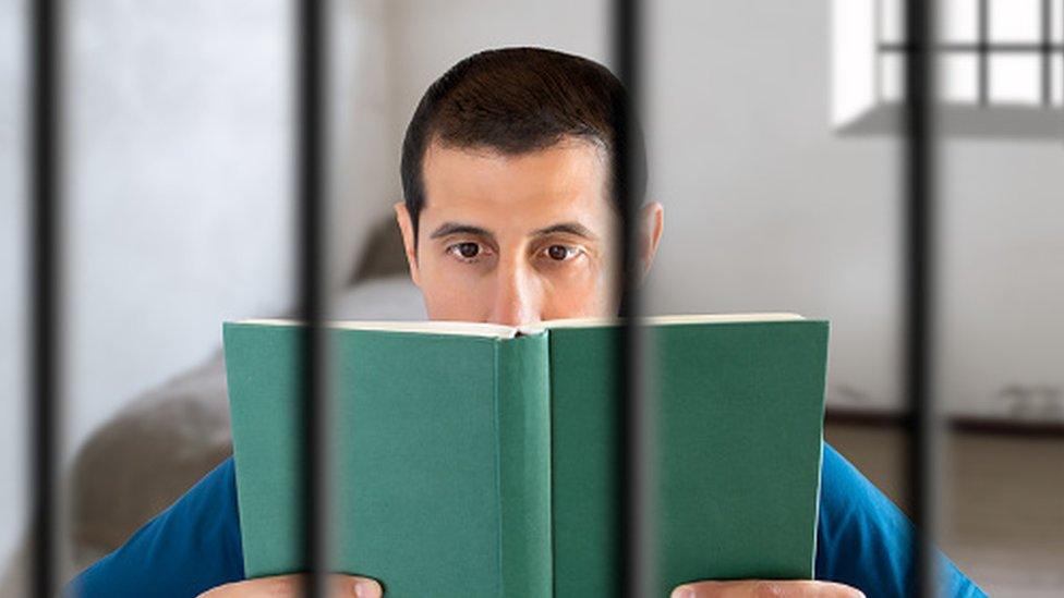 Prisoner with book