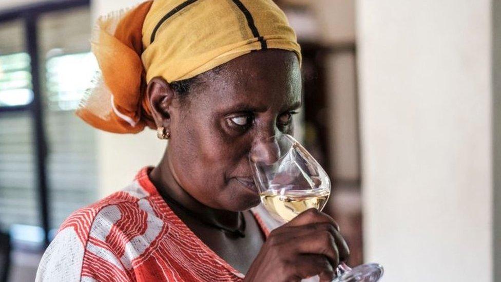 A worker of Awash Wine smells a glass of wine during a wine testing organized for employees in the farm of Awash Wine, in the area of Merti, 120 kilometres from Addis Ababa, Ethiopia, on June 24, 2022