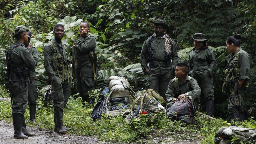 Farc rebels rest by the side of the road as they march towards a demobilisation zone in Cauca province, in Colombia, on 31 January 2017.