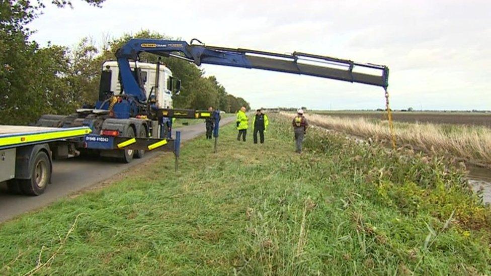 Car being winched out of ditch