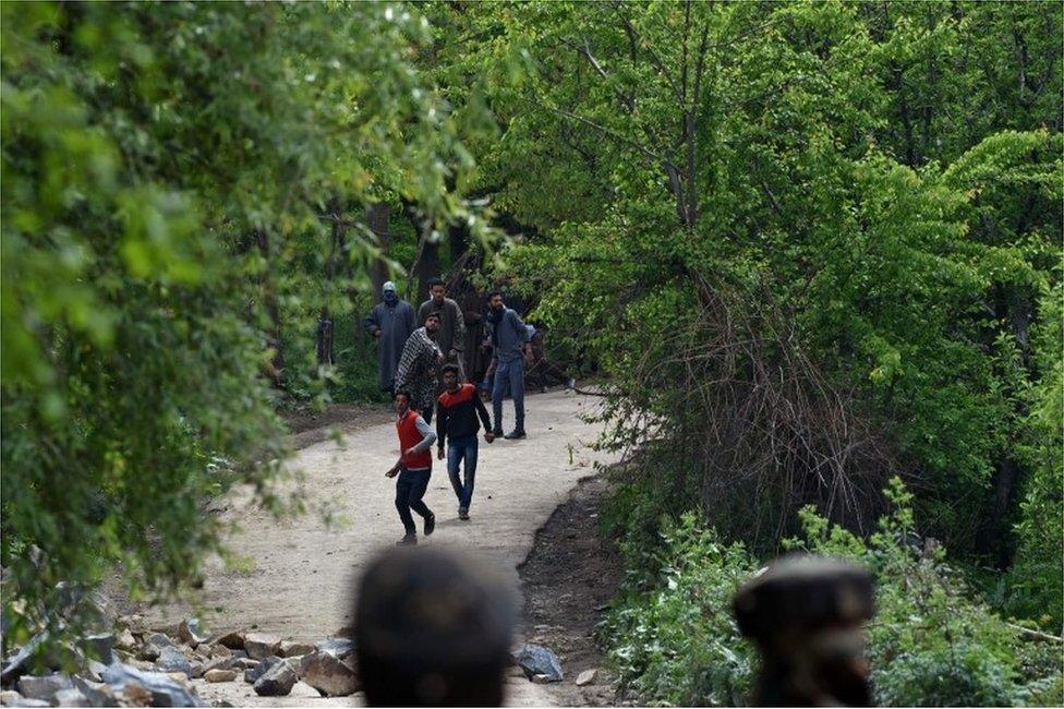 Kashmiri villagers throw stones towards Indian army soldiers as they conduct an operation against suspected rebels in Turkwangam Lassipora in Shopian south of Srinagar on 4 May 2017