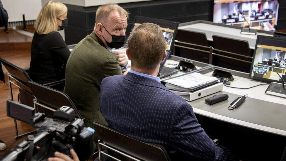 The trial of a Danish man (in the blue suit) who is suspected of murder and attempted murder of a German couple on board the Viking Sally ferry in the summer of 1987, 24 May 2021