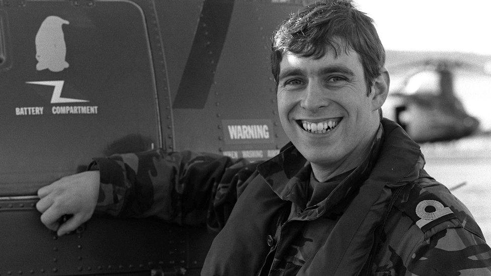 Prince Andrew at Port Stanley stands next to a helicopter for HMS Invincible