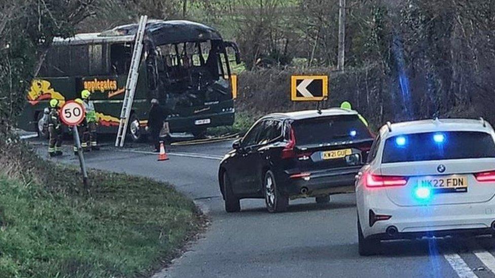 A damaged bus after a fire was put out