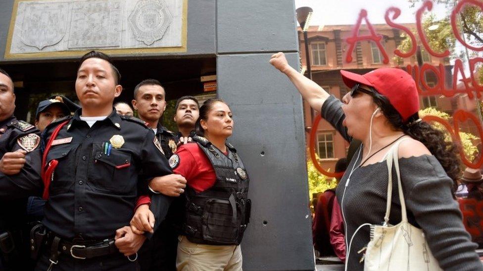 A woman shouts slogans during a protest called by civil organizations against the police