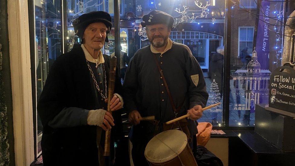 Two men in Tudor costume, one with a recorder and one with a drum