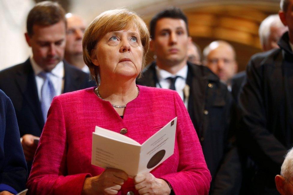 German Chancellor Angela Merkel attends the 500th anniversary of the Reformation in front of the grave of Martin Luther at the Castle Church in Wittenberg, Germany, 31 October 2017