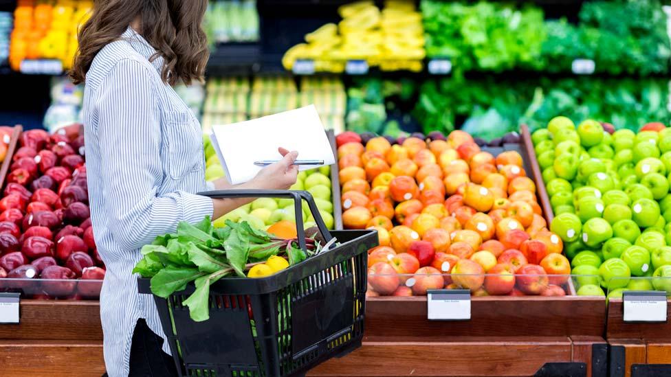 Woman buying vegetables and fruit