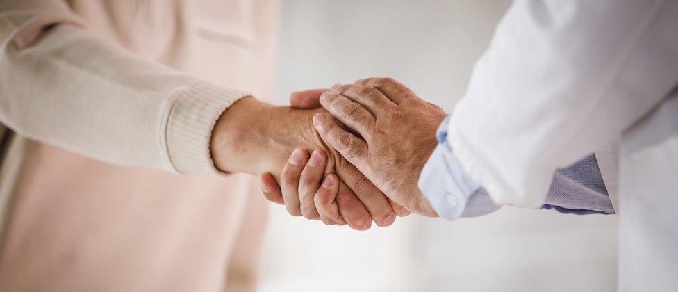 A patient with Parkinson's shaking a doctor's hand (stock image)