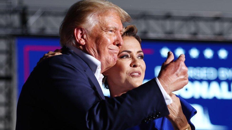 Kari Lake embraces former US President Donald Trump at a rally