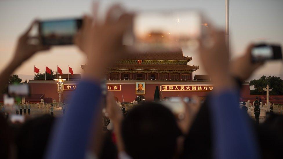 Smartphones in front of Beijing's Forbidden City