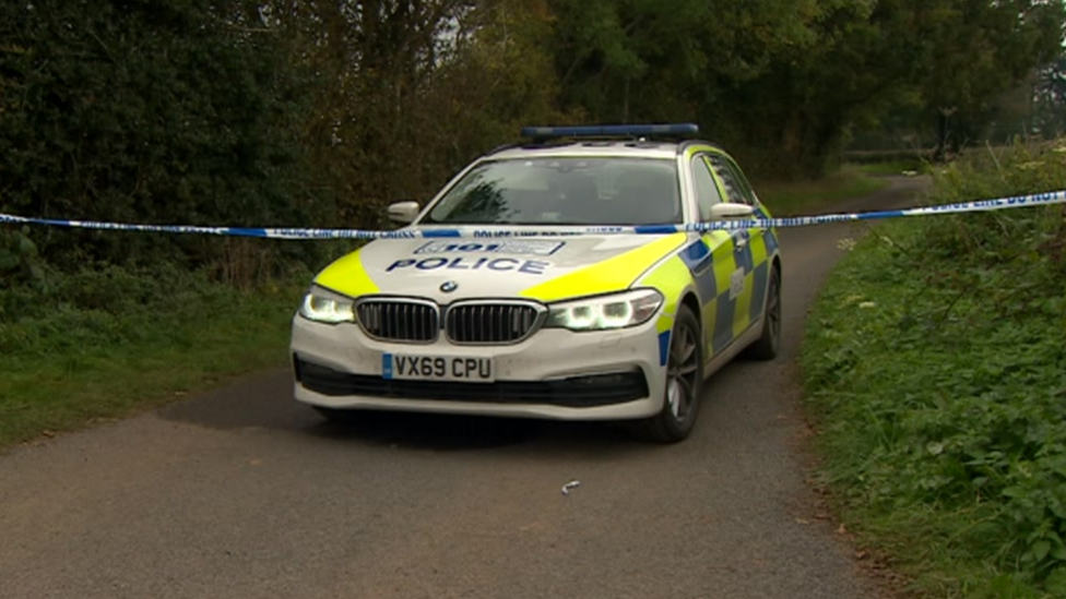 Police car in lane with tape