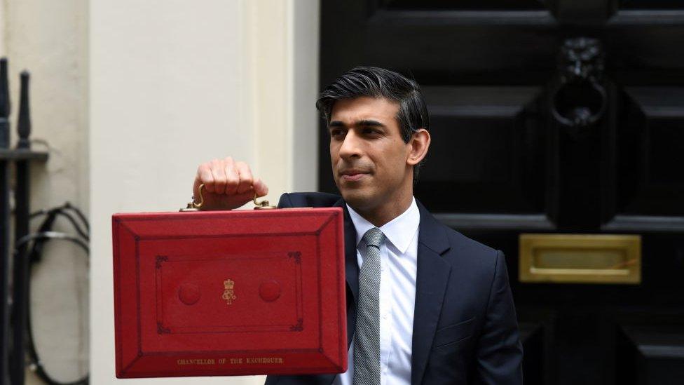 Rishi Sunak holding the red budget briefcase