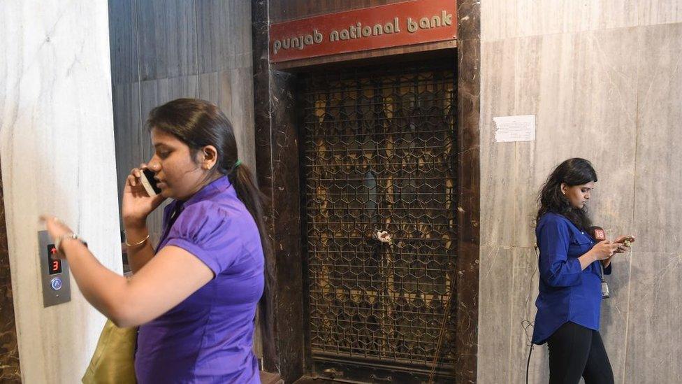 Two women outside closed PNB branch