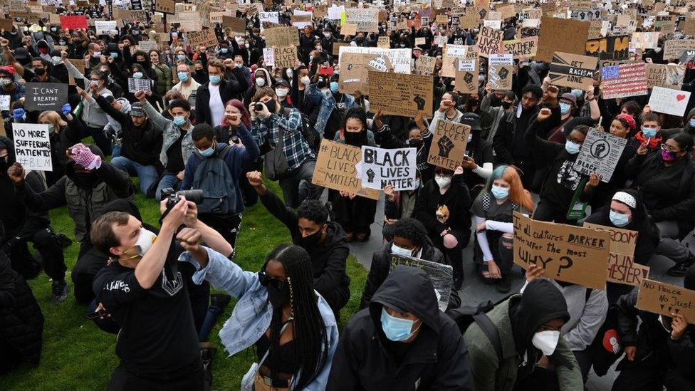 protestors-with-signs-in-Manchester.