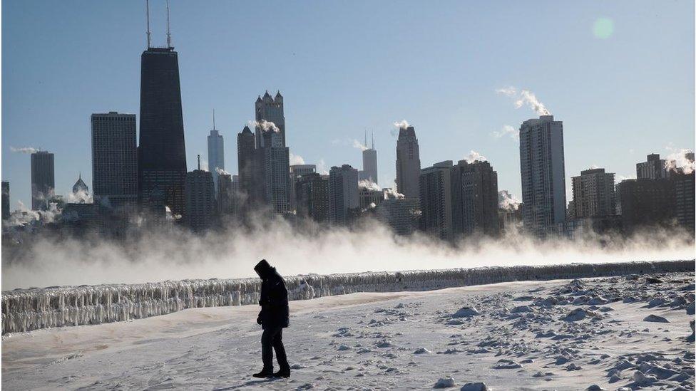 A man walks along the lakefront in Chicago