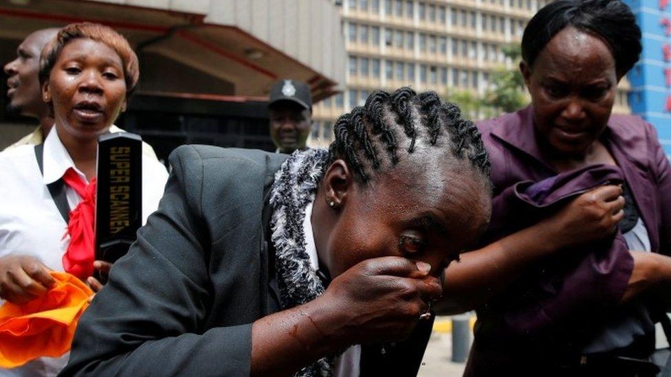Women washing faces after tear gas