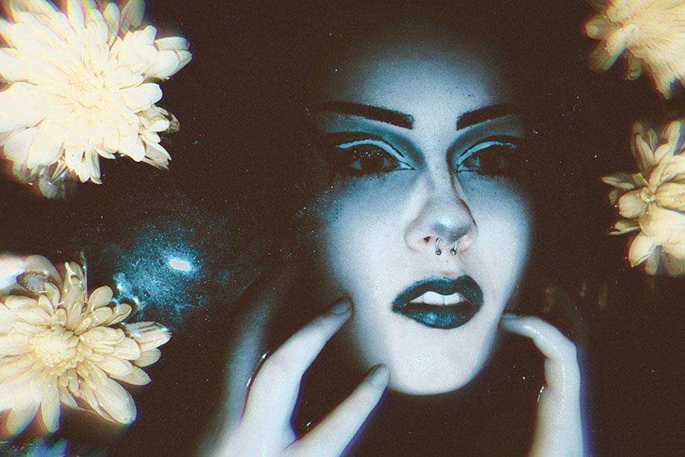 A photo montage showing a woman's face surrounded by flowers