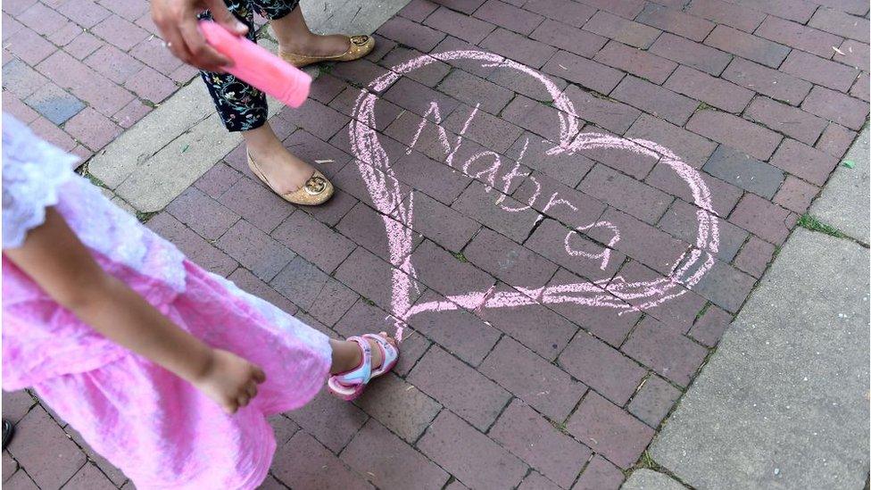 Nabra's name appears in chalk at a vigil for Nabra Hassanen at Lake Anne Plaza June 21, 2017 near Reston, VA