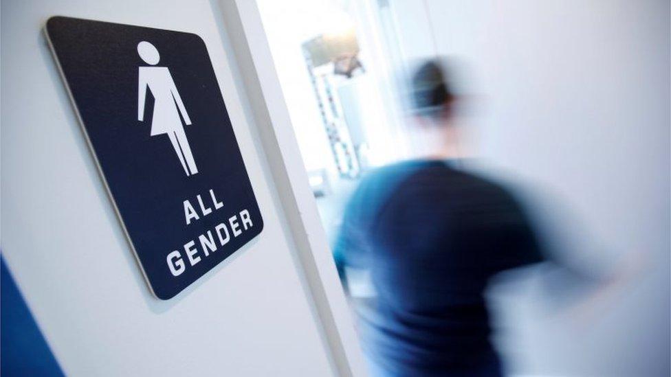 A bathroom sign welcomes both genders at a coffee shop in Durham, North Carolina.