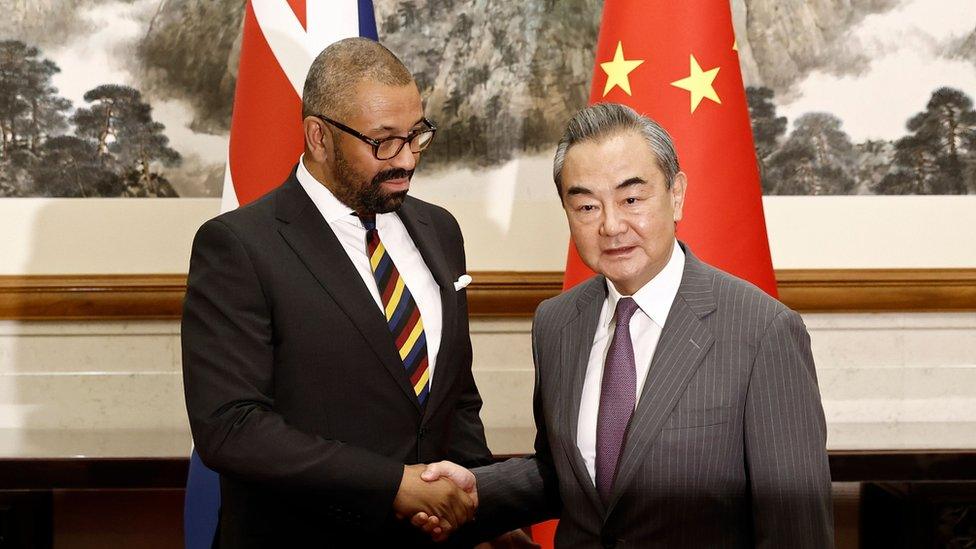 British Foreign Secretary James Cleverly and Chinese Foreign Minister Wang Yi shake hands before a meeting at the Diaoyutai State Guesthouse in Beijing, China