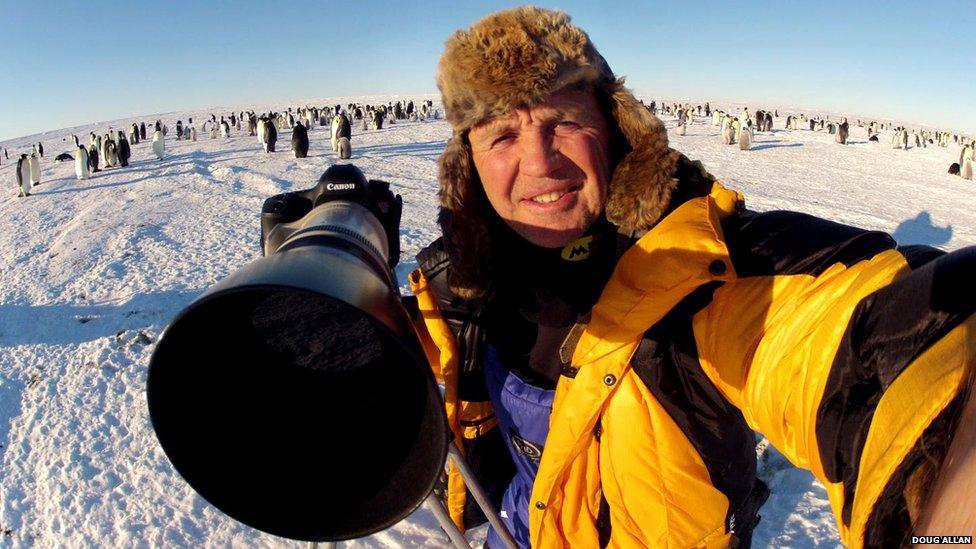 Doug Allan with penguins