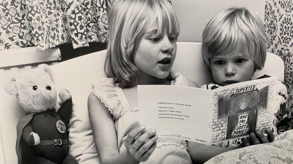 Mike's stepson Richard being read a SuperTed book by Mike's daughter Sarah in the early 1980s