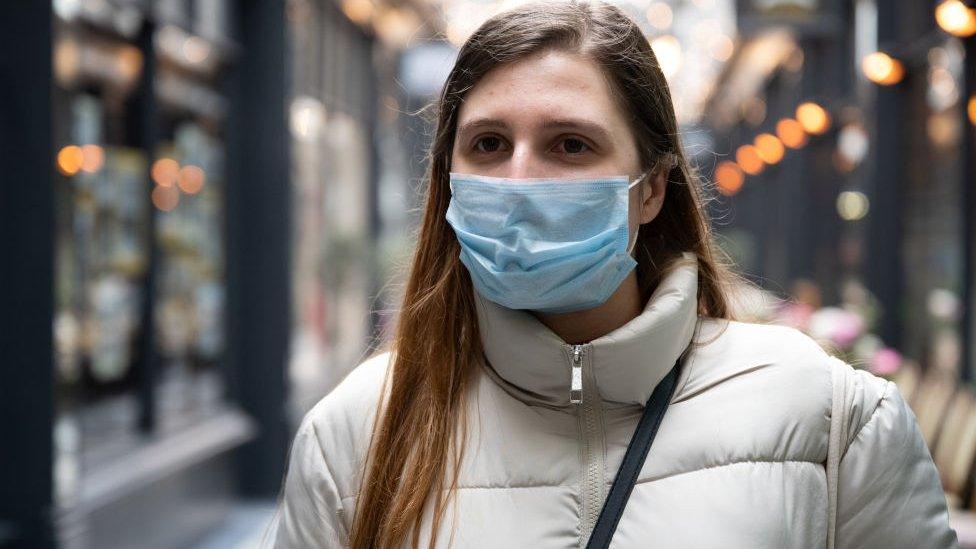 A woman wearing a face mask