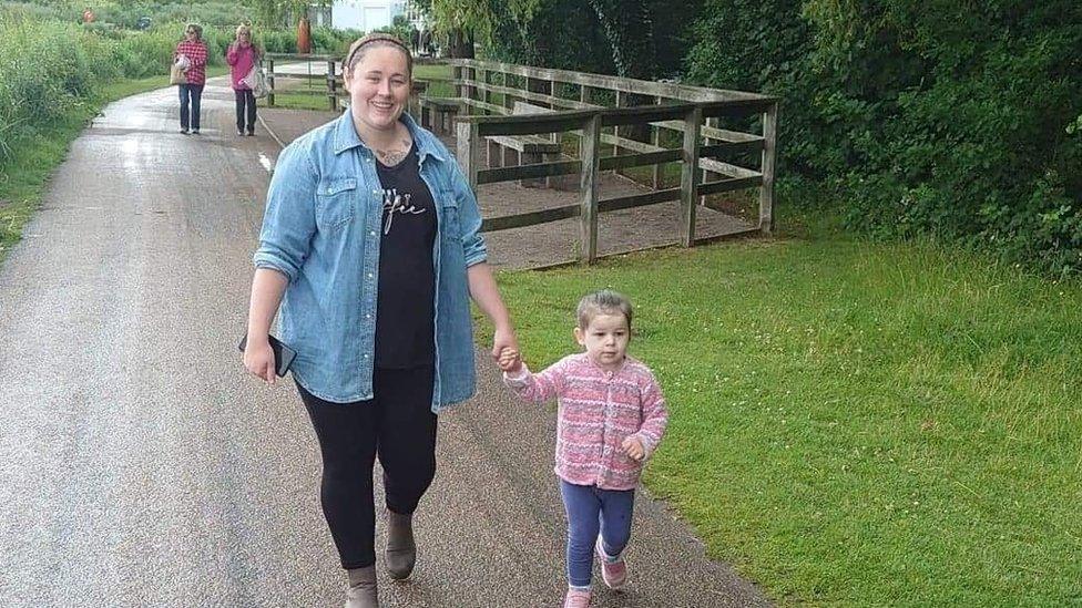 Grace and Hannah holding hands in park