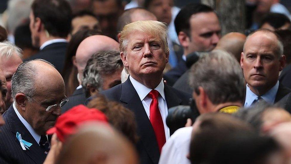 Republican presidential candidate Donald Trump (C) attends a commemoration ceremony for the victims of the September 11 attacks at the National September 11 Memorial and Museum in New York, 11 September