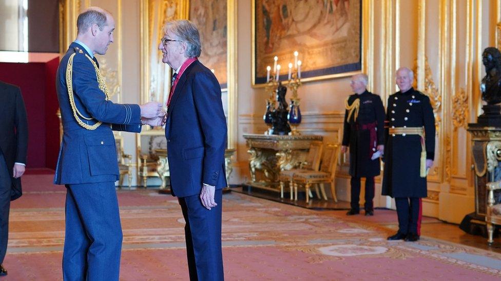 Paul Smith receiving the honour from Prince William