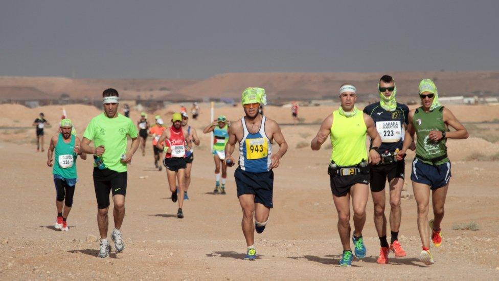 runners against a dark sky