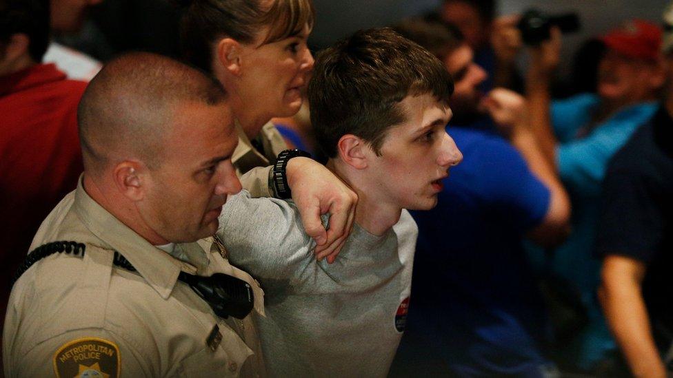 Police remove protestor Michael Steven Sandford as Republican presidential candidate Donald Trump speaks at the Treasure Island hotel and casino in Las Vegas