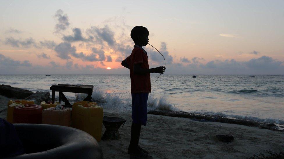 Boy looking out to sea in Mogadishu, Somalia - Friday 4 November 2016