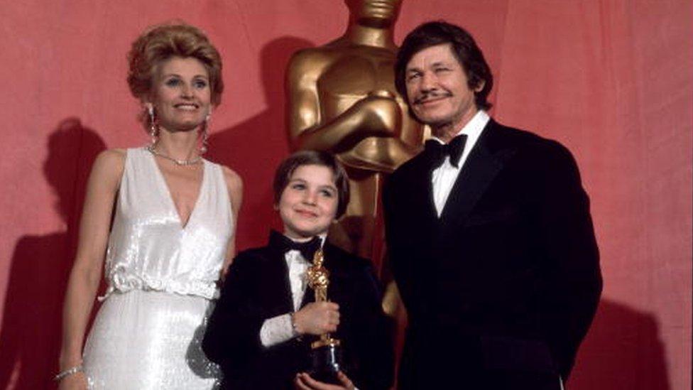 Tatum O''Neal with Charles Bronson and Jill Ireland after winning for ''Paper Moon'' April 3, 1974 at the 46th Annual Academy Awards at the Los Angeles Music Center in Los Angeles, California.