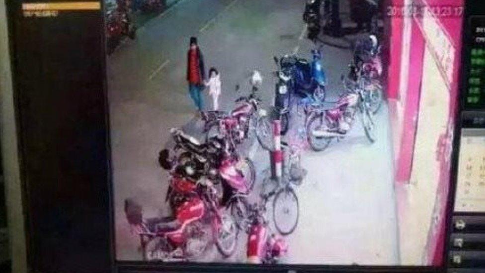 A security camera image showing the girl being abducted, published on social media by Chinese police