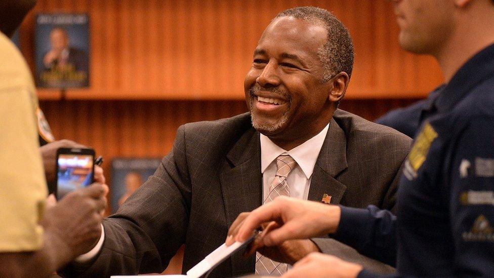 Ben Carson signs copies of his latest book.