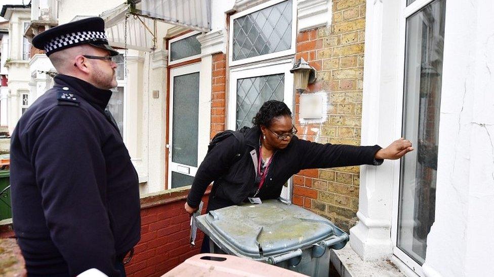 Police and a council enforcement officer conducting a raid