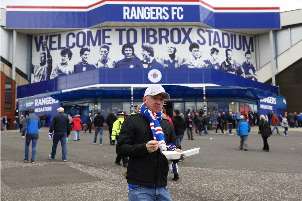 A Rangers fan arrives at the stadium prior to kickoff during the Ladbrokes Scottish Premiership match between Rangers and Celtic at Ibrox Stadium on April 29, 2017